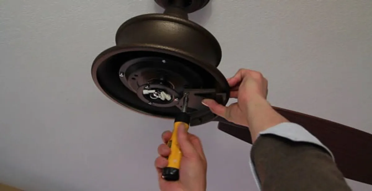 Electrician installing ceiling fan mounting bracket and fixture in Pasadena, CA
